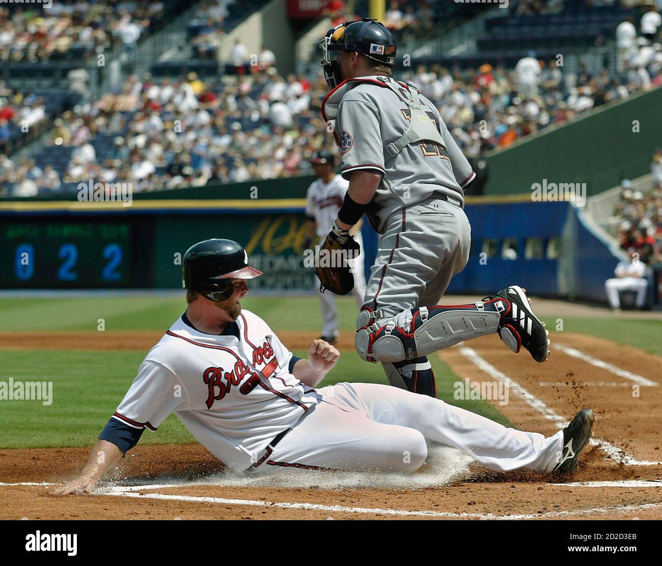 Atlanta Braves runner Brian McCann (L) slides into homeplate safely past Washington Nationals catcher Robert Fick in the first inning at their National League baseball game in Atlanta, Georgia, August 26, 2006.   REUTERS/Tami Chappell   (UNITED STATES) Stock Photo