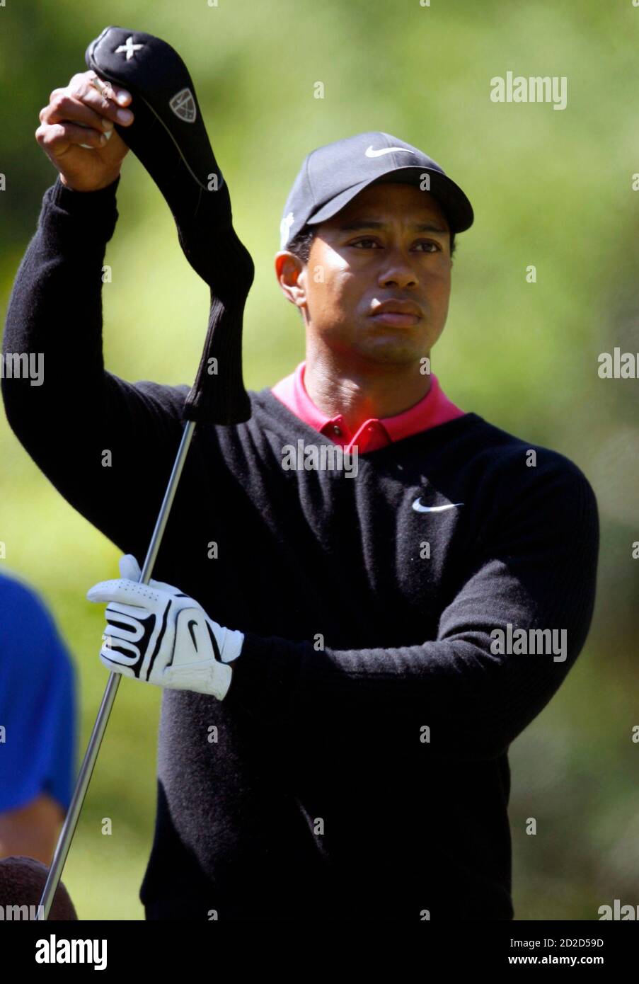 Tiger Woods of the U.S. pulls the cover off his club before hitting on the 7th tee during the final round of the 2007 Masters golf tournament at the Augusta National Golf Club in Augusta, Georgia, April 8, 2007.     REUTERS/Mike Blake (UNITED STATES) Stock Photo