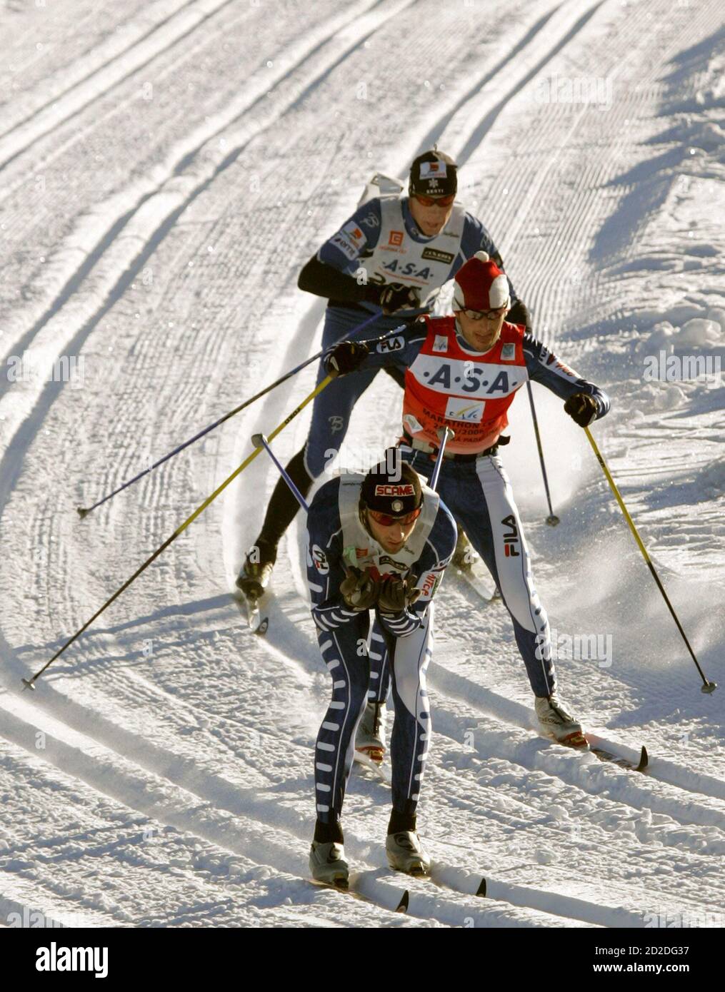 Italy's Marco Cattaneo (front), his team mate Tullio Grandelis and  Estonia's Raul Olle (back) compete during the 39th Jizerska 50 km World Cup  marathon in Bedrichov, near northern Czech town of Liberec