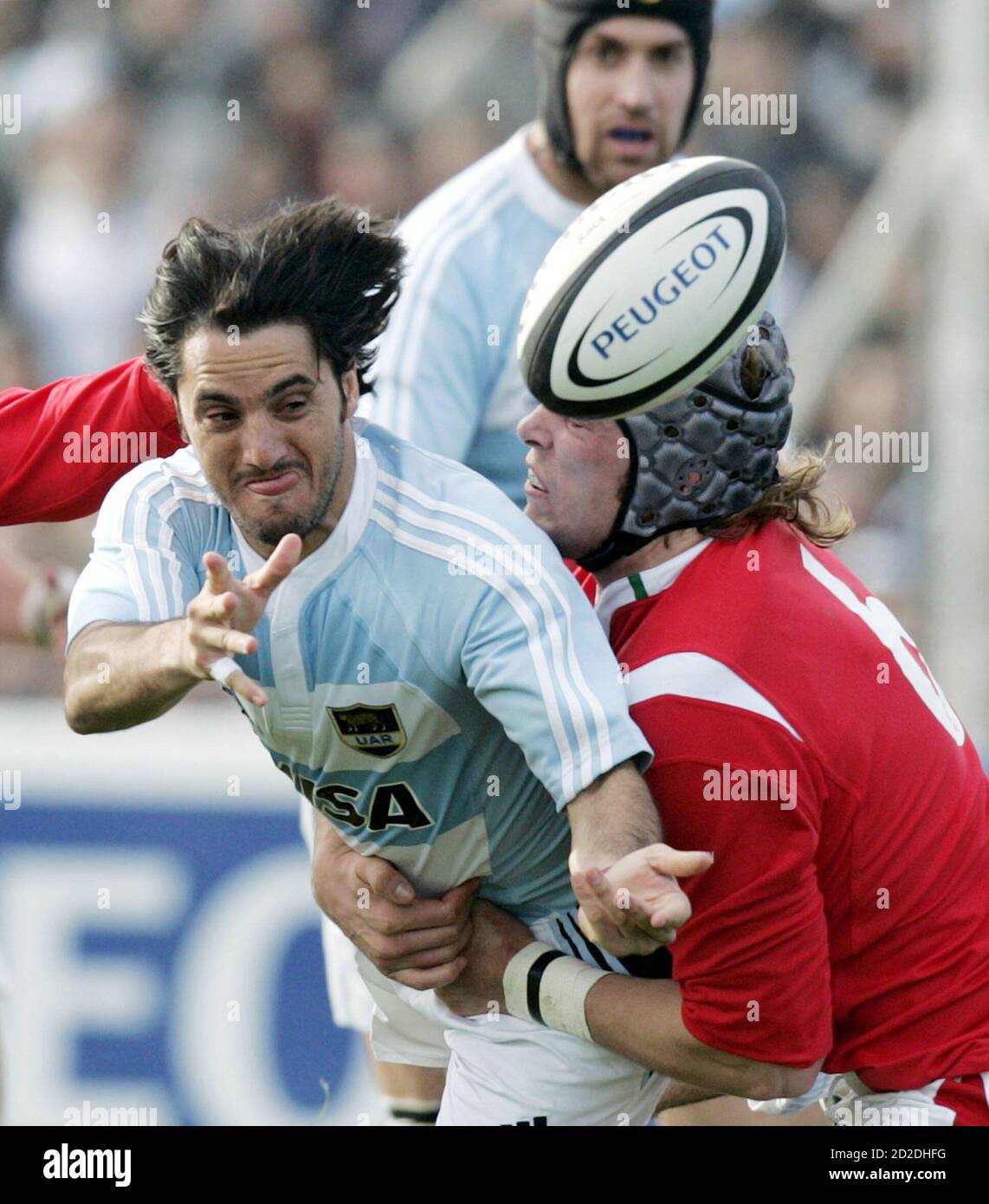 Agustin Pichot (L) of Argentina's Los Pumas is tackled by Alun Wyn Jones of  Wales, as Ignacio Fernandez Lobbe (back) of Los Pumas watches, during their  rugby union test match in Puerto