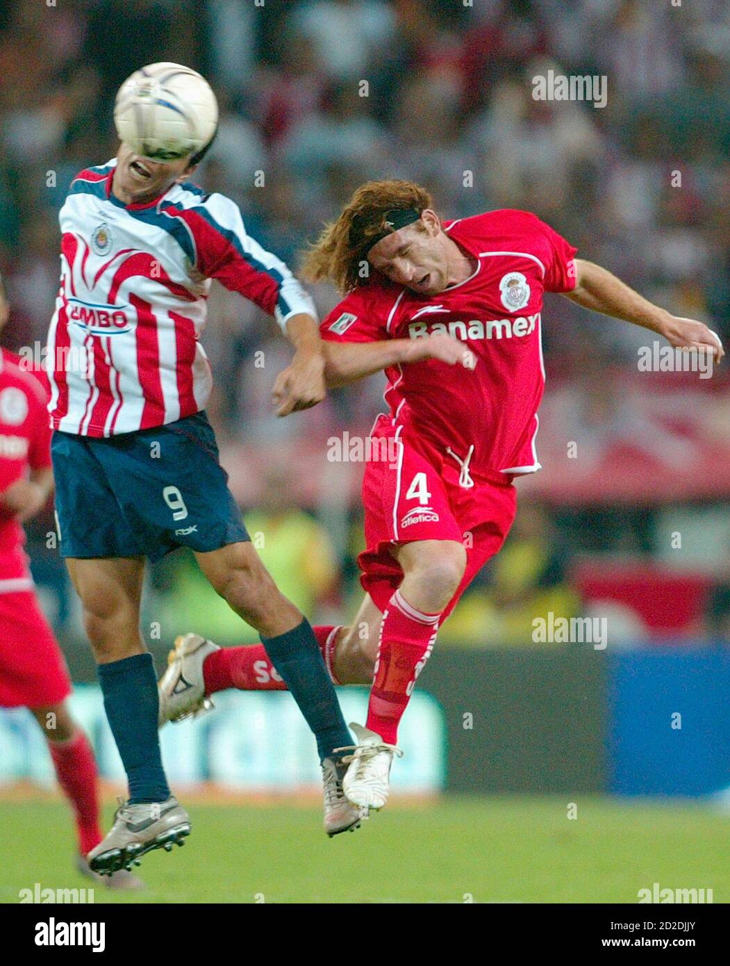 Toluca Midfielder Emilio Hassan R Heads The Ball Against Chivas Striker Omar Bravo During The First Leg Of The Mexican League Championship Final Soccer Match At Jalisco Stadium In Guadalajara City December