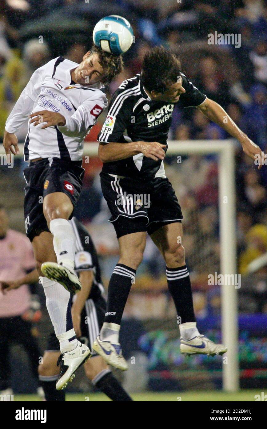 Real Zaragoza's Gerard Pique (L) and Real Madrid's Ruud Van Nistelrooy jump  for the ball during their Spanish First Division soccer match at the La  Romareda stadium in Zaragoza June 9, 2007.