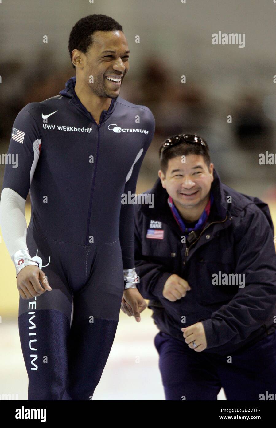 Shani Davis (L) of the U.S. celebrates with his coach Ryan Shimabukuro  after setting the new world record in the men's 1000 m speed skating at the  ISU World Cup Speed Skating