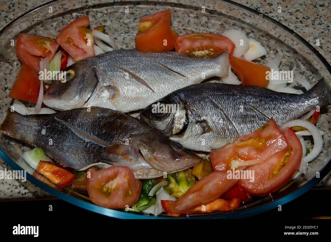 Baking tray with assorted fish and salad. Arinaga. Aguimes. Gran Canaria. Canary Islands. Spain. Stock Photo