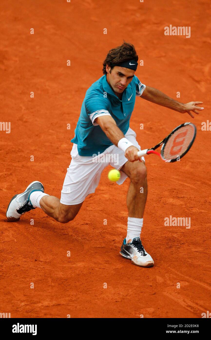 Roger Federer of Switzerland returns the ball to Robin Soderling of Sweden  during the French Open