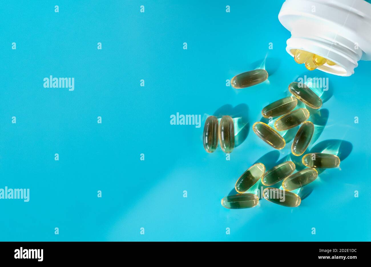 The fish oil capsules are poured out of the bottle Stock Photo Alamy