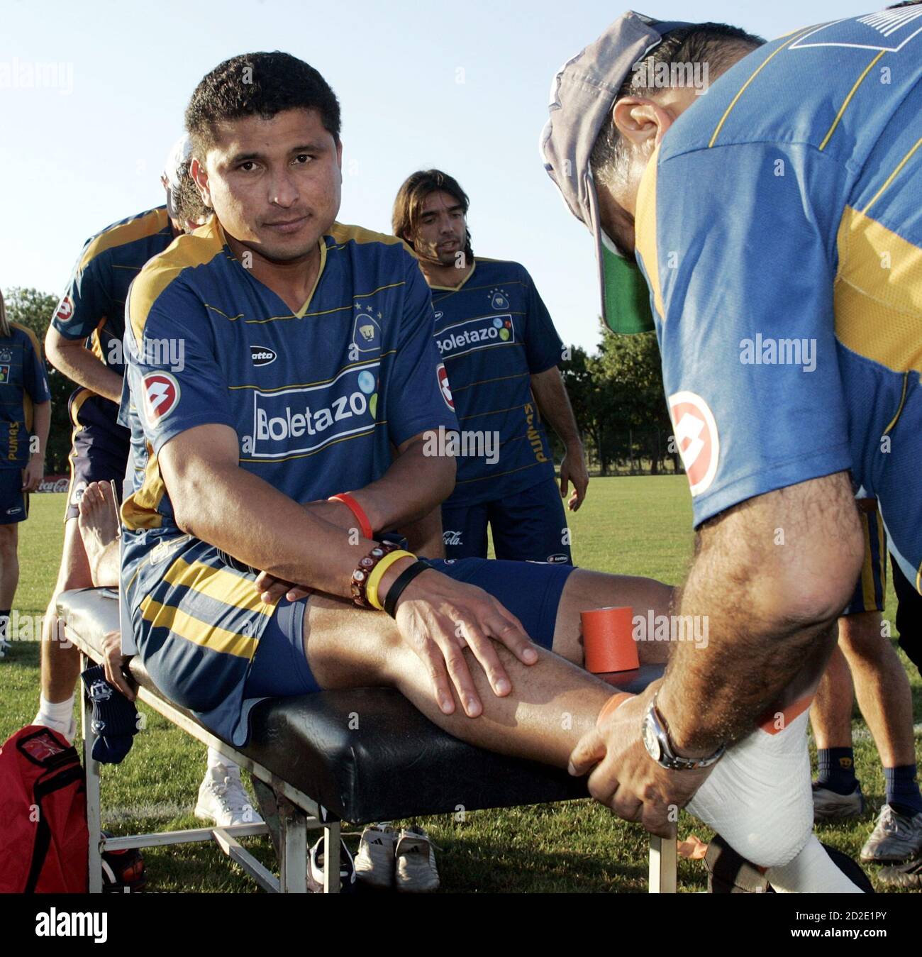 Joaquin Botero of the Mexican soccer team Pumas of Unam has his feet  bandaged before a warm up session with his team in Buenos Aires December  16, 2005. Pumas of Unam faces