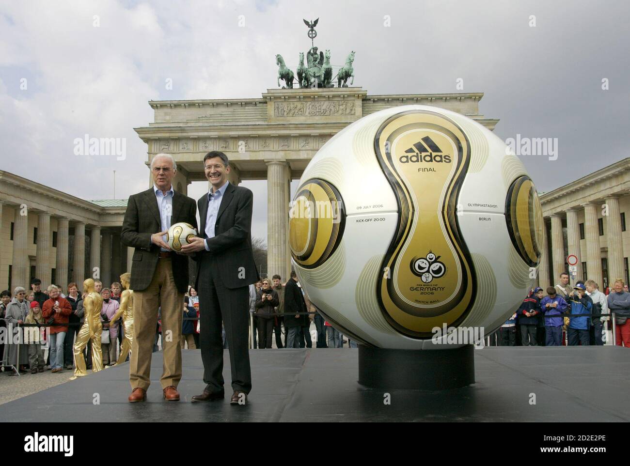 Franz Beckenbauer, President of Germany's World Cup organising committee,  and Adidas CEO Herbert Hainer (R) hold a golden soccer ball during a  presentation next to the Brandenburg gate in Berlin April 18,