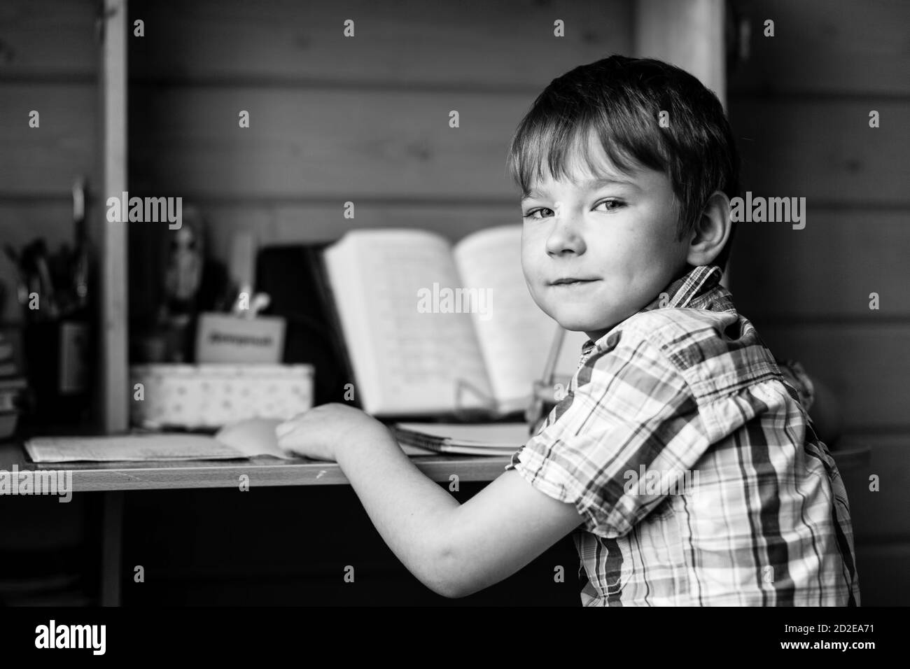 School student doing homework. Black and white photography. Stock Photo