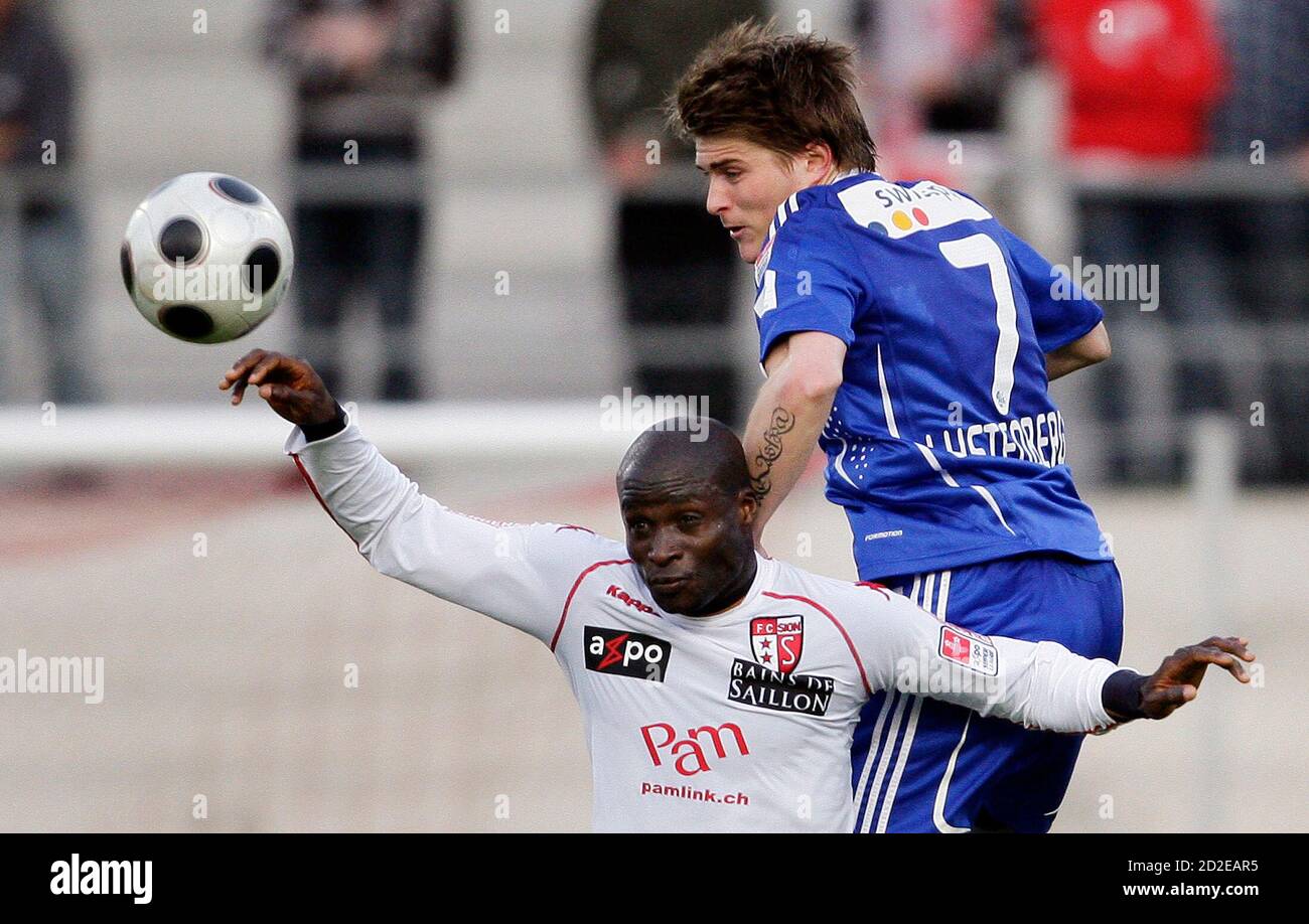 FC Sion's Saidu Adeshina (L) fights for the ball with FC Luzern's Claudio  Lustenberger during their Swiss Super League soccer match in Sion April 4,  2009. REUTERS/Valentin Flauraud (SWITZERLAND SPORT SOCCER Stock