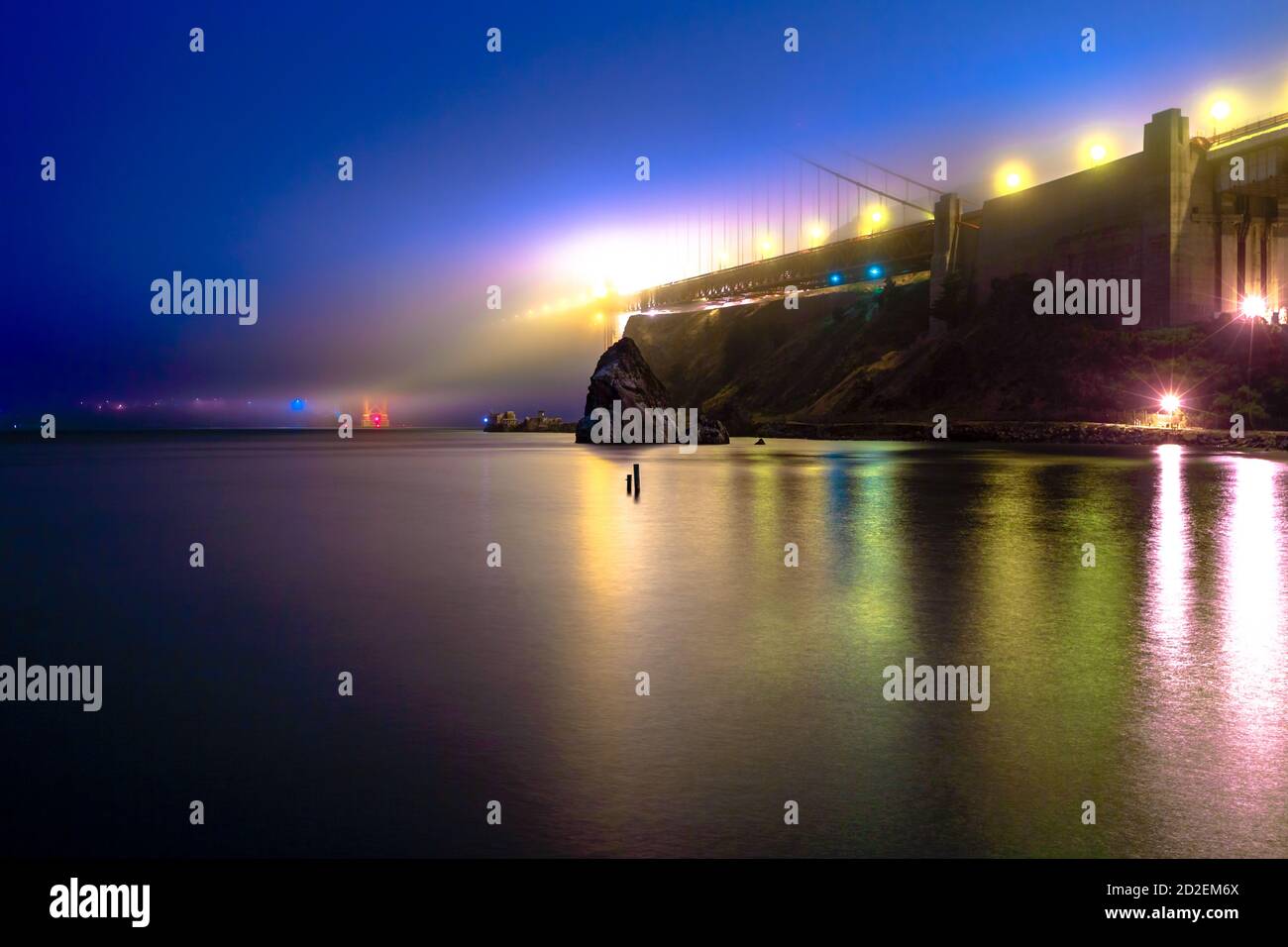 Golden Gate Bridge illuminated at night from Horseshoe Bay in Sausalito, California, United States. The Golden Gate is a symbol of San Francisco Stock Photo