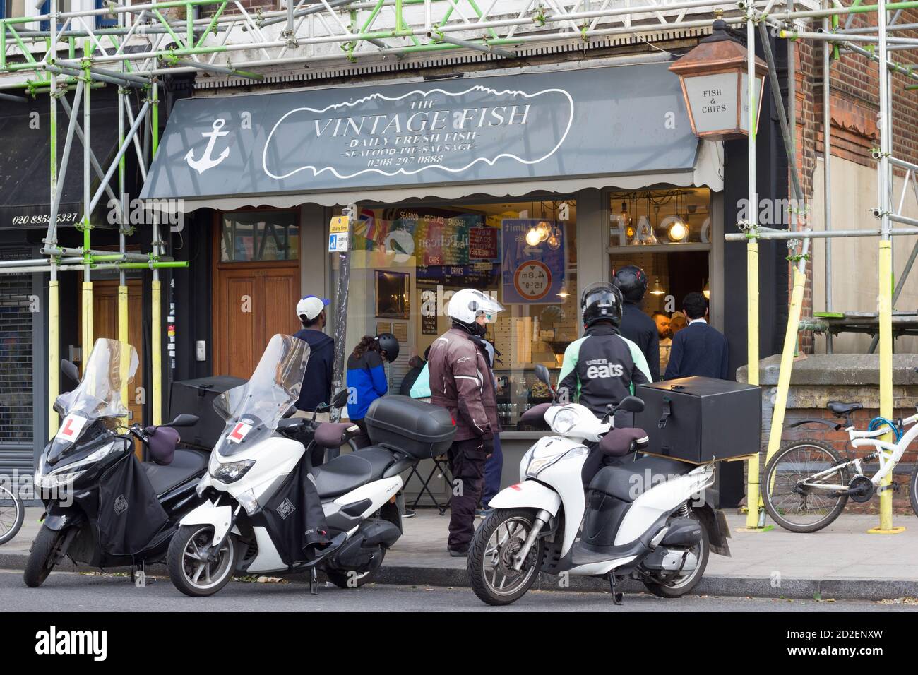 Vintage Fish Takeaway were booming during void-19 lockdown, delivery scooters queuing outside a fast food shop near Blackheath , London, England Stock Photo