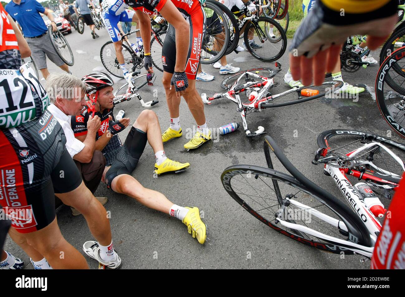 Tour de France doctor Gerard Porte (L) tends to Caisse d'Epargne rider Jose  Joaquin Rojas of Spain after a crash in the pack during the eleventh stage  of the 96th Tour de