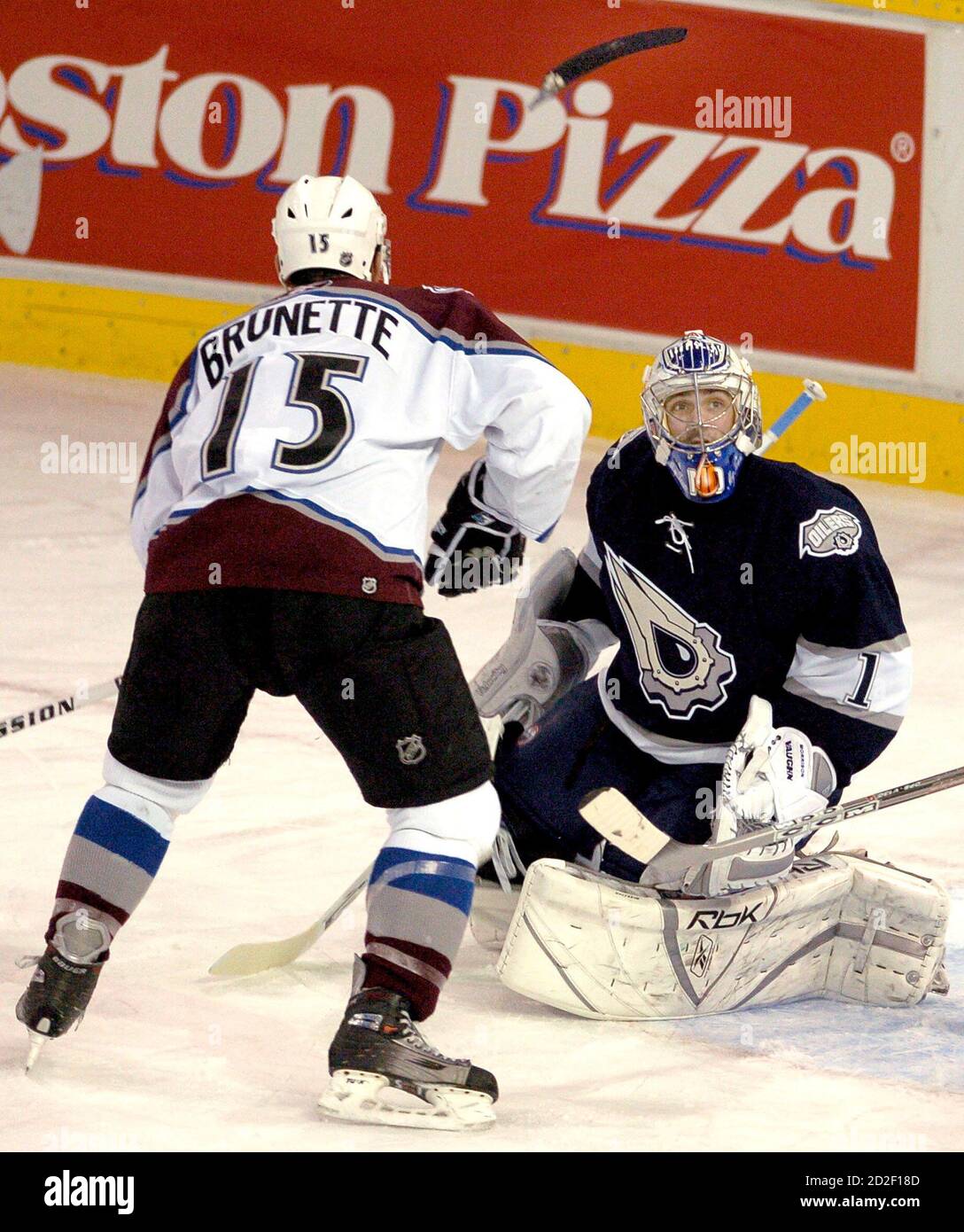 Colorado Avalanche forward Andrew Brunette (15) and Edmonton Oilers goaltender Mike Morrison (R) watch Brunette's broken stick blade fly over their heads during first period NHL action in Edmonton November 29, 2005. The blade broke off the shaft when the puck hit the stick. REUTERS/Dan Riedlhuber Stock Photo
