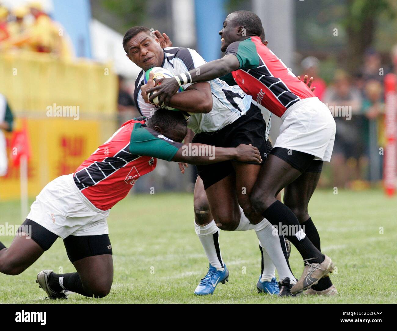Fiji's Etonia Nalibu (C) is tackled by Kenya's Collins Injera (R) during their IRB World Rugby Sevens series quater-final match in George December 8, 2007.  REUTERS/Howard Burditt (SOUTH AFRICA) Stock Photo