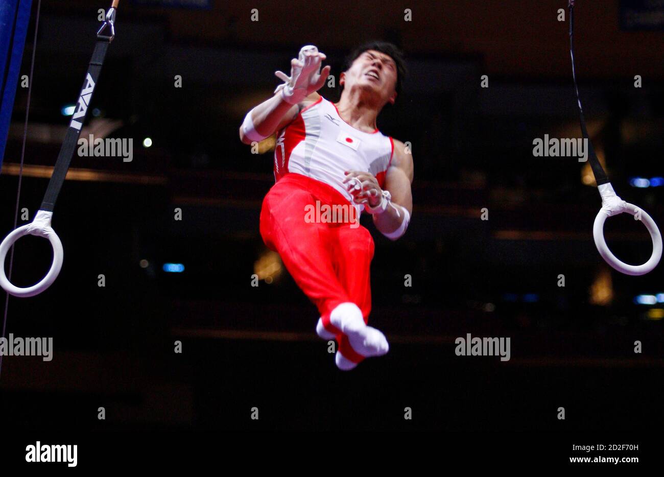 Gymnast Hisashi Mizutori of Japan dismounts from the rings while competing at the Tyson American