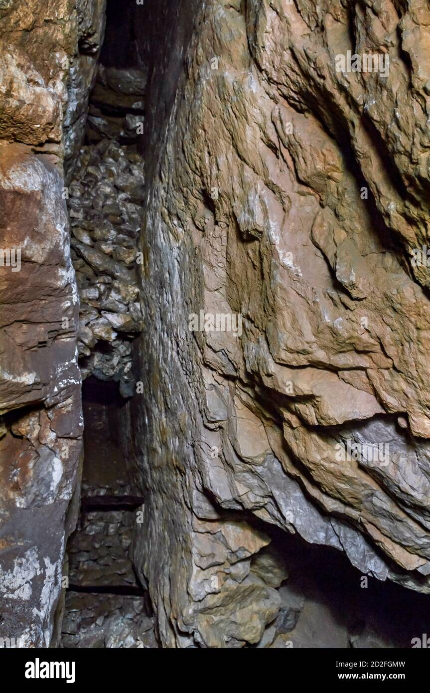 An open 'stope' on a mineral vein, with backfilled waste rock 'deads', and wooden stemples for climbing, in an old lead mine in Derbyshire. Stock Photo