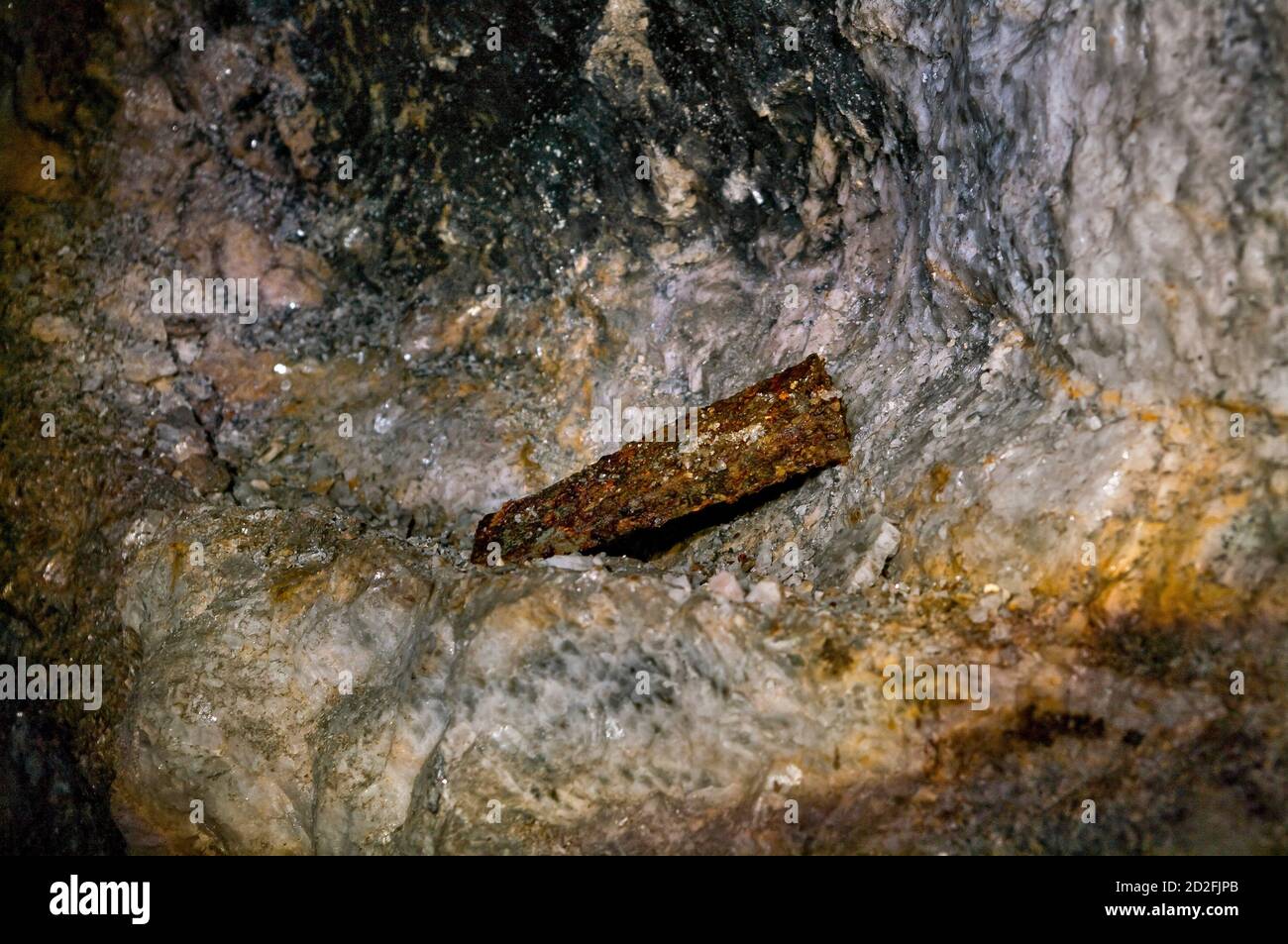 Steel rock-splitting wedge found rusting on a small ledge on a mineral vein in an old lead mine in Derbyshire. Stock Photo