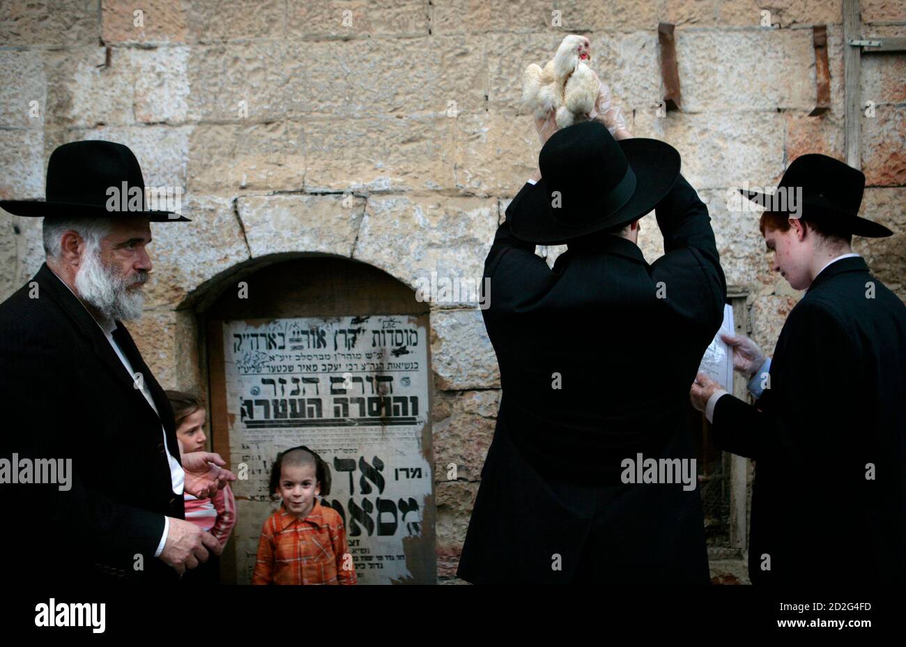Ultra-Orthodox Jews swing a chicken over their heads during a Kaparot  ritual in Jerusalem September 18, 2007. Kaparot is an ancient custom  connected to the Jewish Day of Atonement, Yom Kippur, where