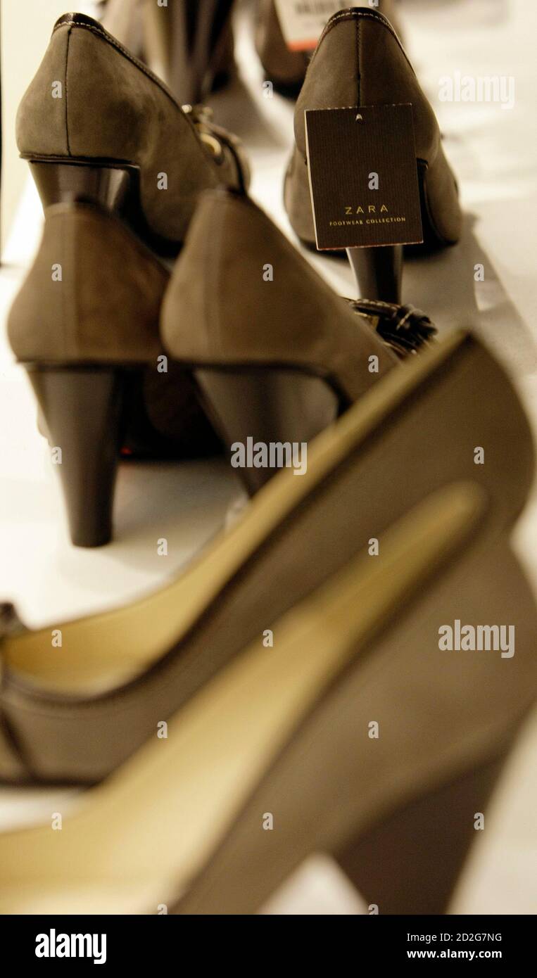 Shoes are displayed inside a Zara store in central Madrid October 20, 2008.  Every piece of Zara clothing sold in nearly 1,500 stores worldwide passes  through this cavernous distribution centre in northern