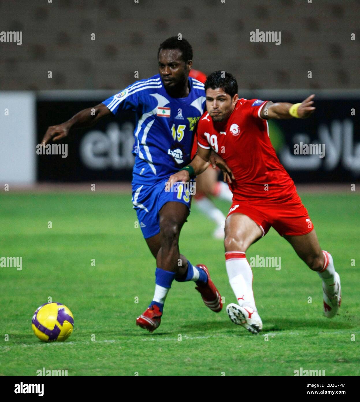 Leandson Da Silva of Bahrain's soccer club Muharraq Club and Derick Ebi of Lebanon's  soccer club SAFA SC fight for the ball during the first leg of their AFC  Cup Final, in