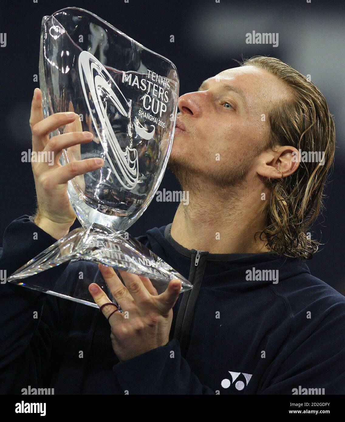 David Nalbandian of Argentina, winner of the Tennis Masters Cup in Shanghai,  kisses the trophy at the end of a match with Roger Federer of Switzerland  November 20, 2005. Nalbandian fought back