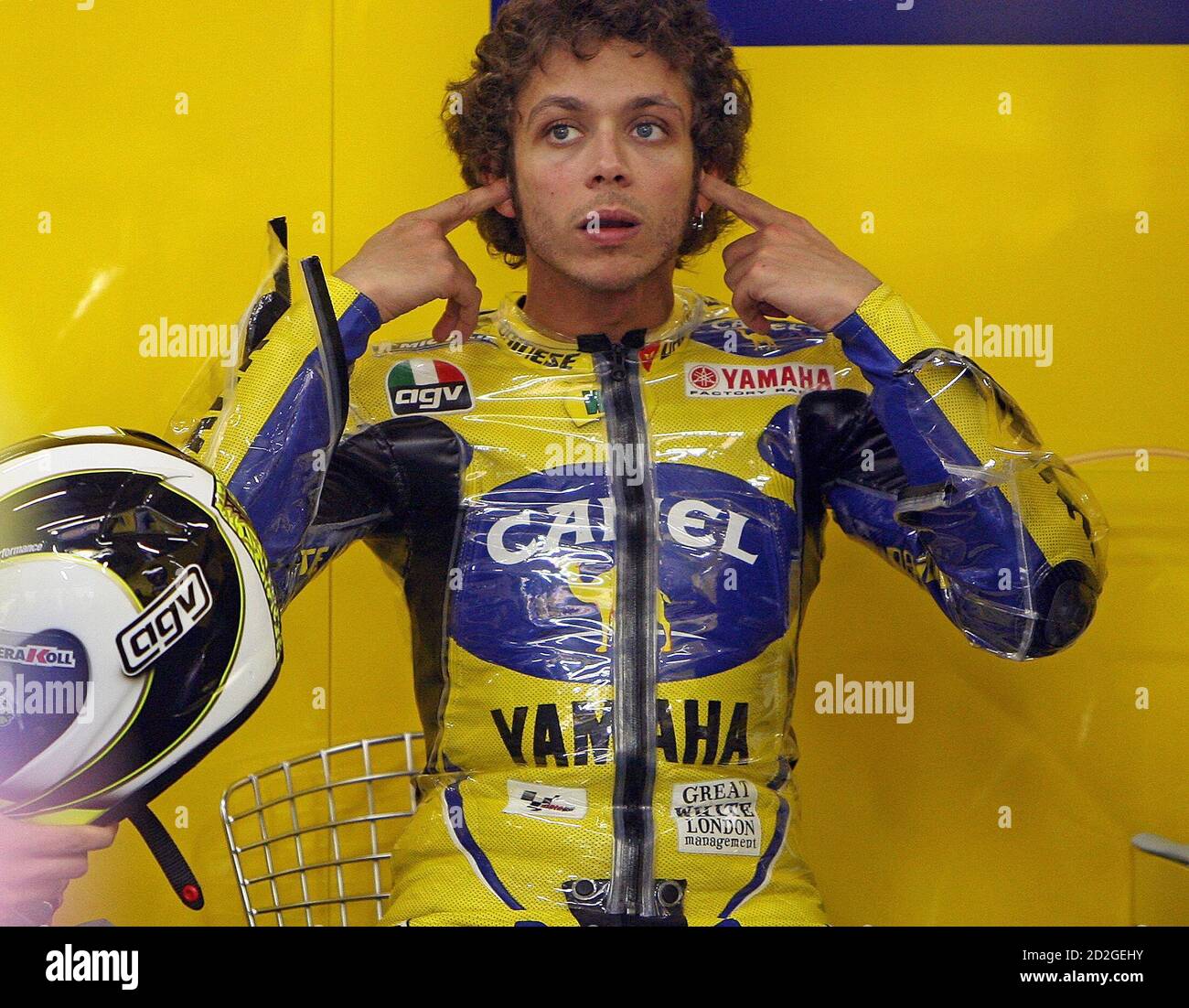 MotoGP world champion Valentino Rossi of Italy sets his ears plugs before  the beginning of the second free practice session for the 2006 China MotoGP  in Shanghai May 12, 2006. The race