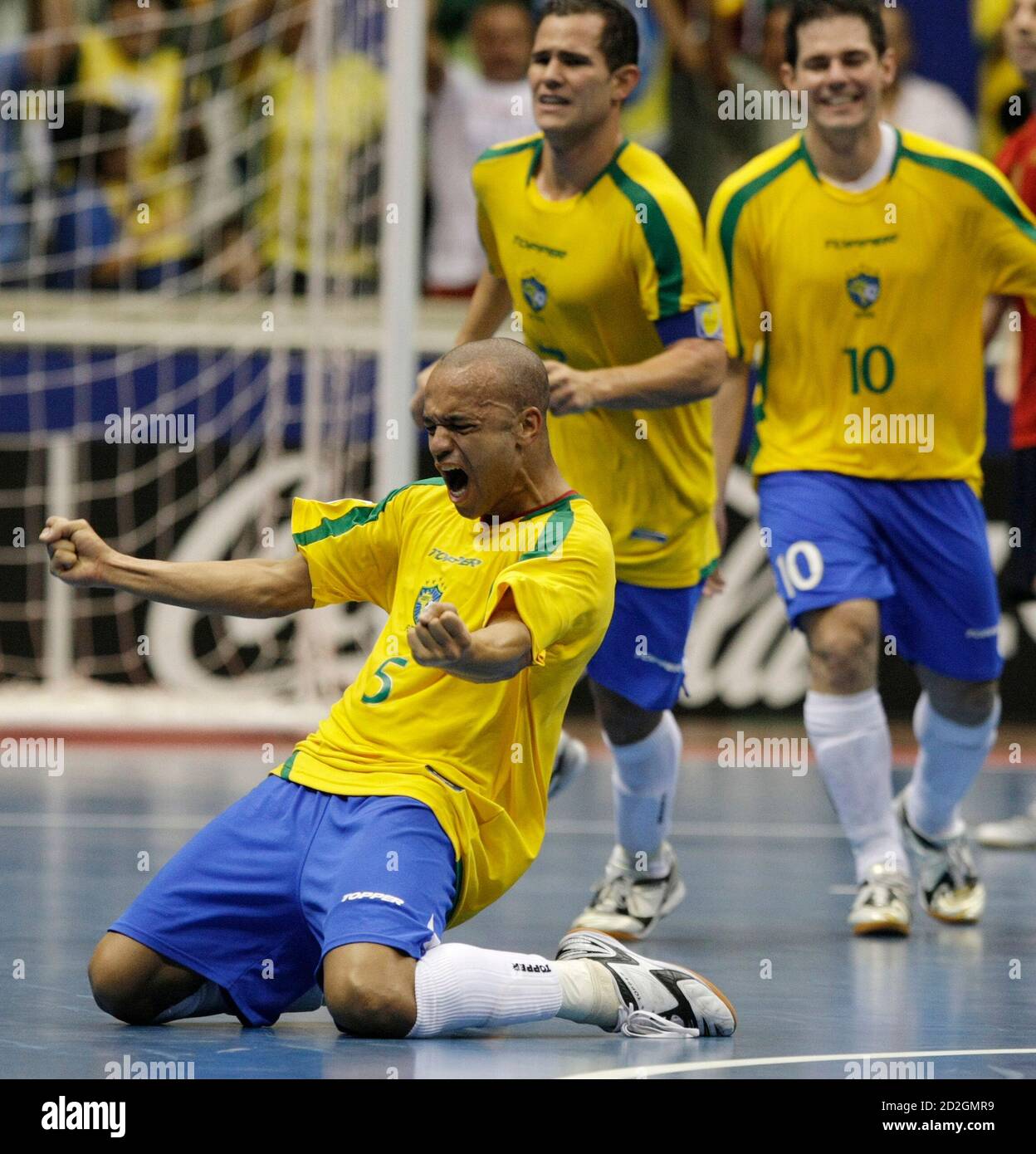 Cico (L) of Brazil celebrates his teammate Vinicius' (C) goal against Spain as Brazil's Lenisio reacts during their FIFA Futsal World Cup final soccer match at the Gimnasio Maracanazinho in Rio de Janeiro October 19, 2008. REUTERS/Sergio Moraes  (BRAZIL) Stock Photo