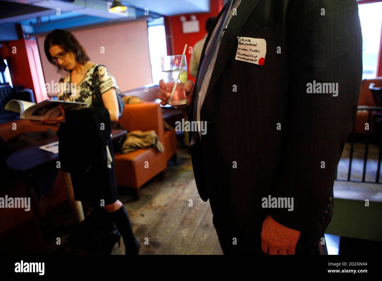 Jan Kodadek reads through a brochure as another man holds a drink during a  recruitment event at a pub in New York March 25, 2009. The group calls  itself 
