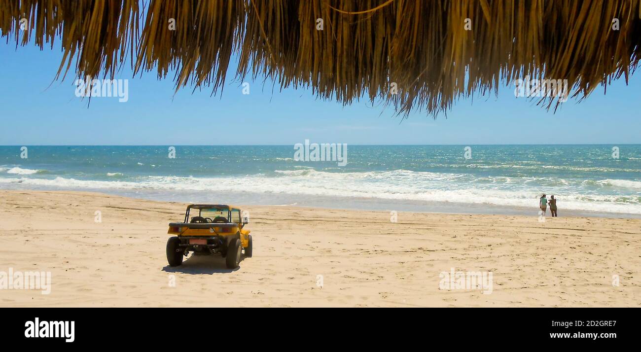 Two women and beach buggy on beach Stock Photo