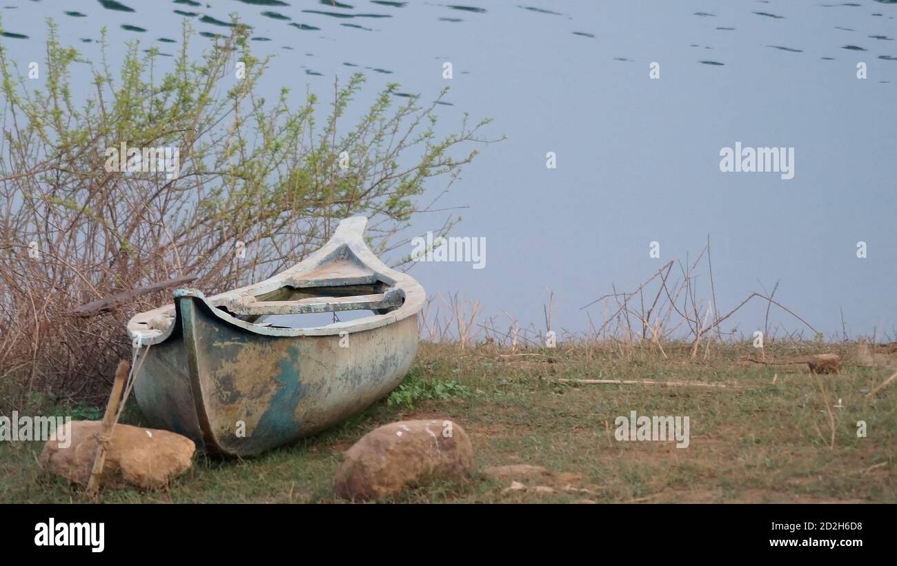wooden boat on the bank of a river Stock Photo - Alamy