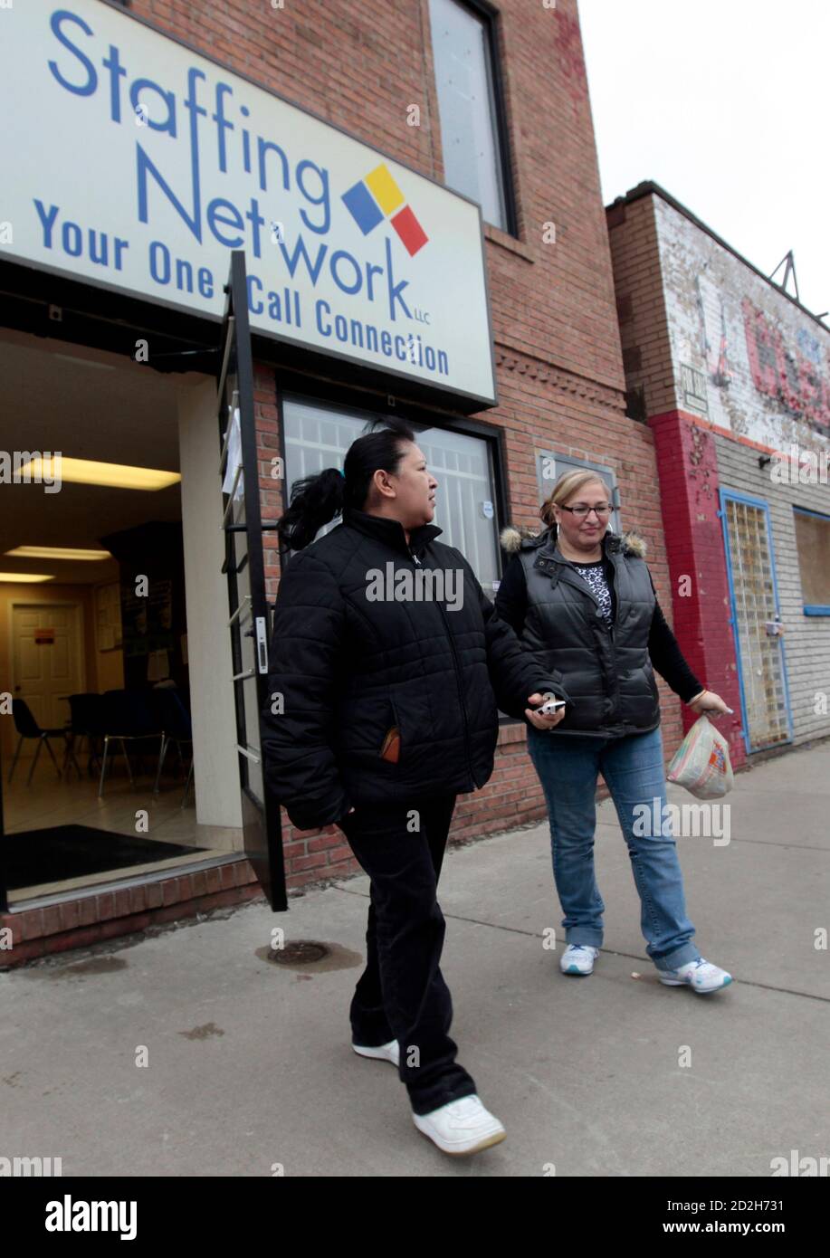 Two job seekers leave a temporary work agency in Southwest  Detroit, Michigan April 3, 2009. The U.S. unemployment rate soared to 8.5% last month, a 25-year high, as employers slashed 663.000 jobs and cut workers' hours to the lowest level on record, the government said on Friday.  REUTERS/Rebecca Cook  (UNITED STATES BUSINESS POLITICS) Stock Photo