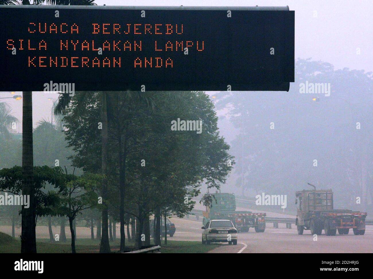 An Electronic Board Displays Weather Hazy Turn On Your Headlights As A Driving Precaution On A Malaysian Speedway In Sungai Buloh Outside Kuala Lumpur August 12 2005 Malaysians Prayed For Rain On