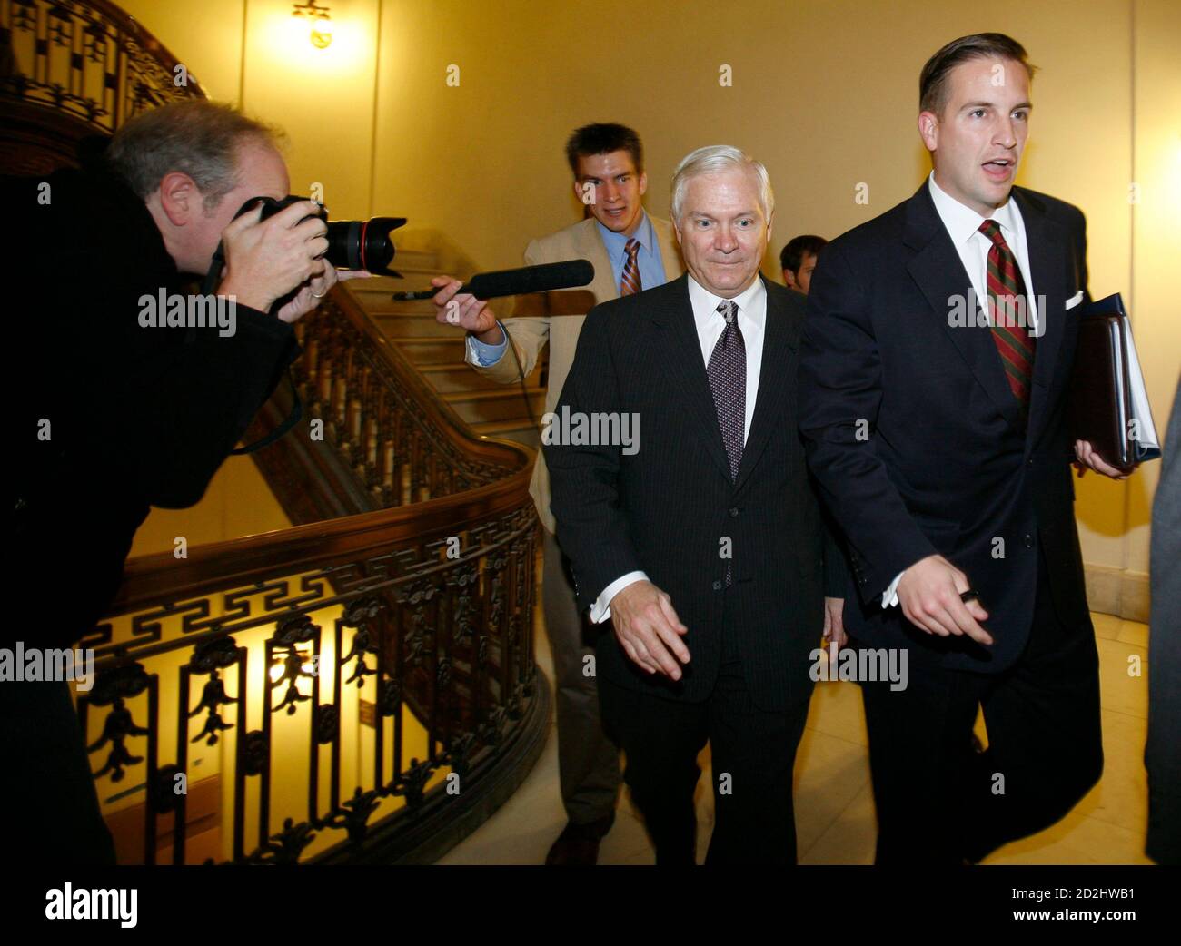 U.S. Secretary of Defense nominee Robert Gates (C) is followed by the press (L) and ushered by staff (R) from the Russell Senate Office building following a meeting with U.S. Senator Carl Levin on Capitol Hill in Washington, November 20, 2006. Gates is expected to begin Senate confirmation hearings on his appointment to replace Donald Rumsfeld as Secretary of Defense in early December.    REUTERS/Jason Reed (UNITED STATES) Stock Photo