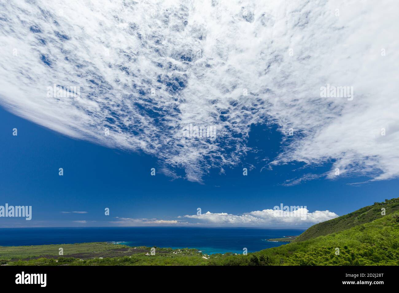 Use of polarizing filter to bring out clouds and darken sky over Kealakekua Bay in South Kona, Hawai’i Island Stock Photo