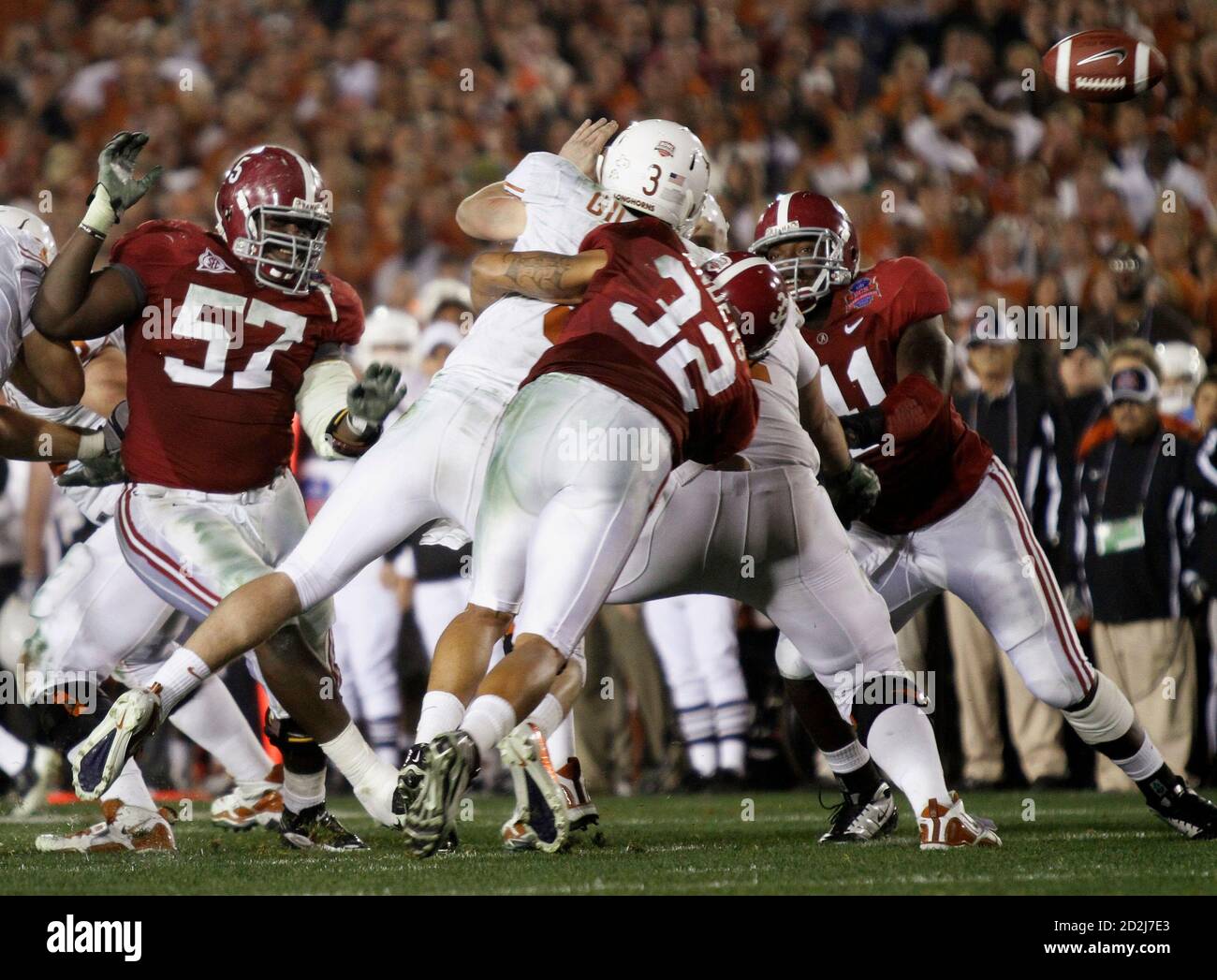 texas-longhorns-quarterback-garrett-gilbert-3-fumbles-the-ball-as-he-is-hit-by-alabama-crimson-tides-eryk-anders-c-next-to-alabama-crimson-tides-marcell-dareus-l-and-courtney-upshaw-r-during-the-fourth-quarter-in-the-ncaas-bcs-national-championship-football-game-in-pasadena-january-7-2010-reuterslori-shepler-united-states-tags-sport-football-2D2J7E3.jpg