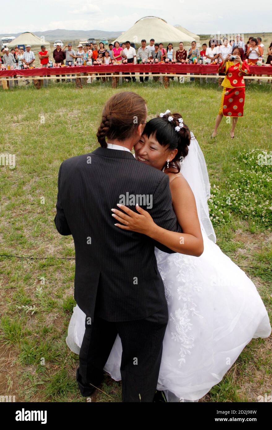 https://c8.alamy.com/comp/2D2J98W/sean-quirk-r-of-us-from-milwaukee-wisconsin-and-his-bride-chaiganmaa-ondar-originally-from-tuva-dance-during-their-open-air-wedding-ceremony-outside-the-city-of-kyzyl-in-the-tuva-region-on-the-mongolian-border-some-736-km-457-miles-south-of-the-siberian-city-of-krasnoyarsk-july-18-2010-quirk-inspired-by-tuvan-throat-singing-moved-from-the-united-states-to-russias-tuva-region-seven-years-ago-where-he-is-currently-a-member-of-the-tuvan-national-orchestra-and-in-2008-was-named-a-merited-artist-of-tuva-for-his-work-on-behalf-of-tuvan-music-and-culture-reutersilya-naymushin-2D2J98W.jpg