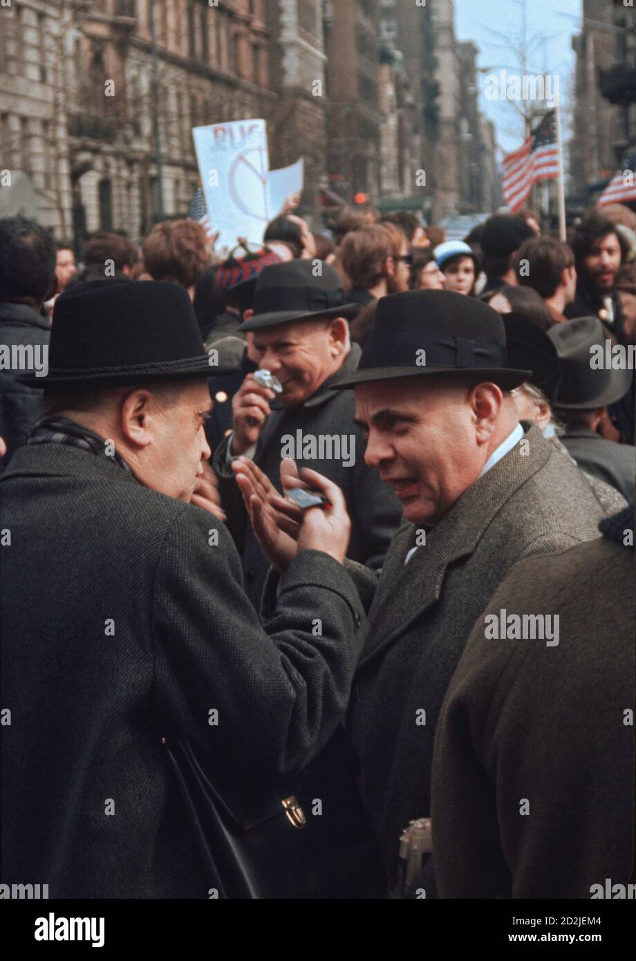 Discussion around Anti-War Protest March on Fifth Avenue in New York City March 26, 1966 with two men exchange opinions. Stock Photo