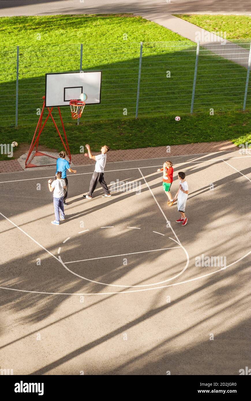 Children playing basketball outdoor at sunny day Stock Photo Alamy