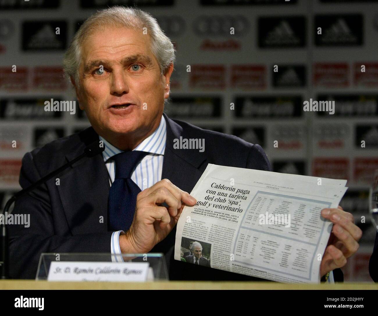 Real Madrid's President Ramon Calderon holds up a newspaper reading  "Calderon uses the club's credit card to pay for his spa, vet and golf"  during a news conference in Madrid October 30,