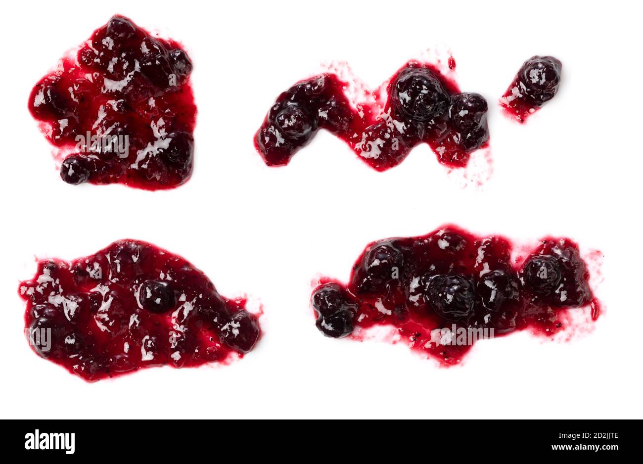 A bird's-eye view of the various shapes of blueberry jam hanging down on a white background. Stock Photo