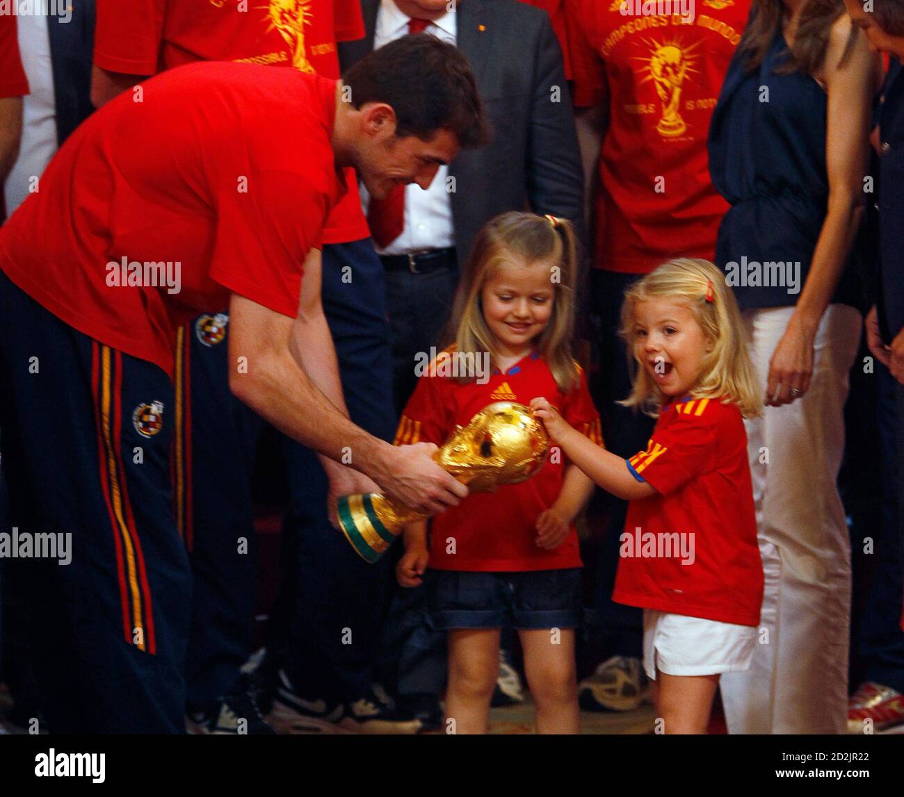 Spain's Infantas Sofia (R) and Leonor react as Spain's captain Iker  Casillas (L) shows them the World Cup trophy during a reception at Madrid's  Royal Palace July 12, 2010. Spain stunned the