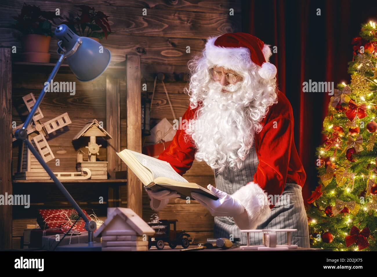 Santa claus sitting table gifts hi-res stock photography and images - Alamy