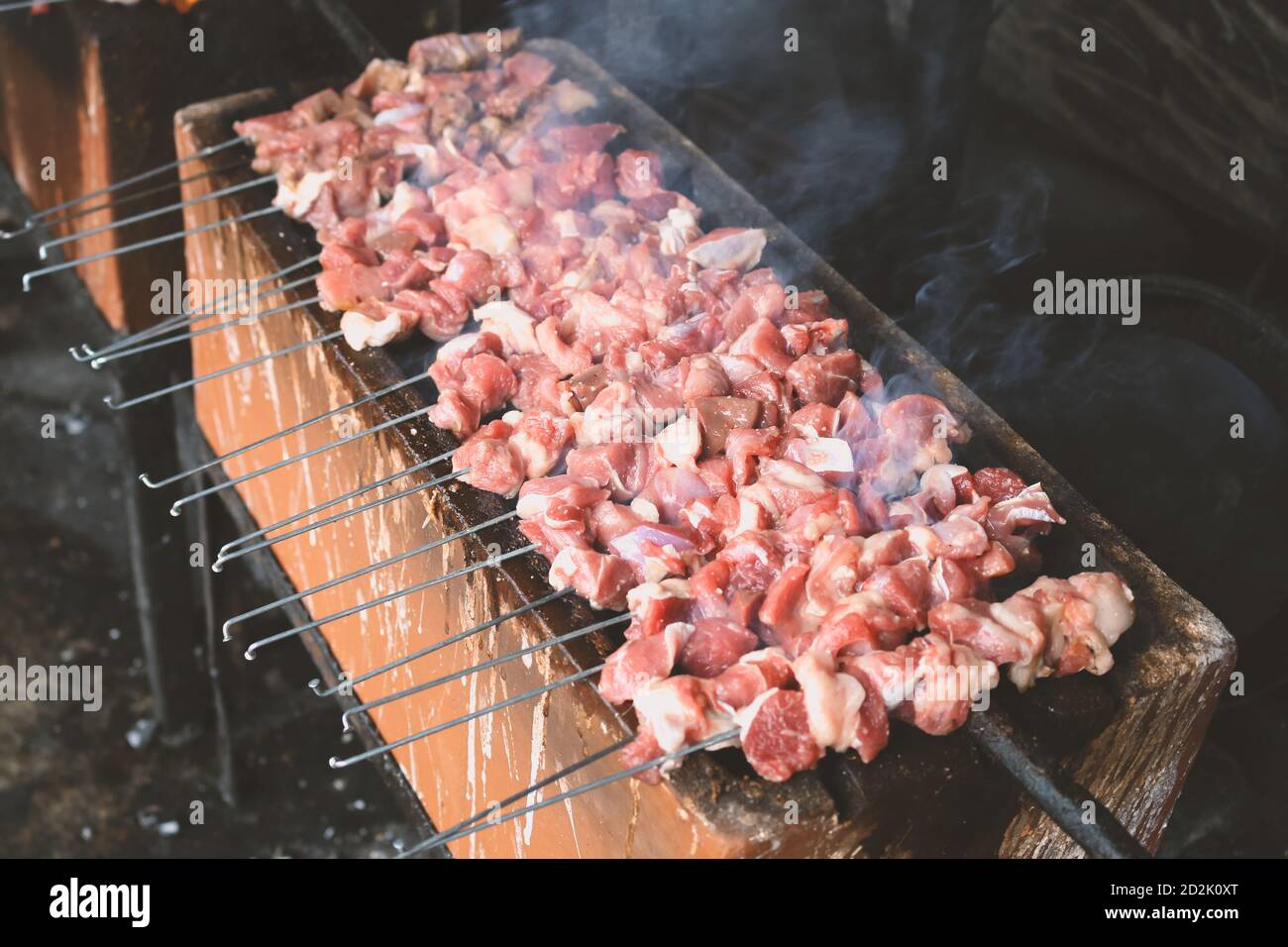 Sate Klatak grilling on charcoal grill. Sate klathak is a unique goat satay or mutton satay dish, originally from Yogyakarta, Indonesia. Stock Photo