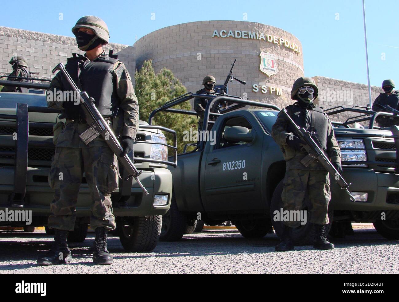Mexican army soldiers stand guard outside the headquarters of municipal  police in the border city of Ciudad Juarez March 16, 2009. The army took  control of the Ciudad Juarez municipal police force