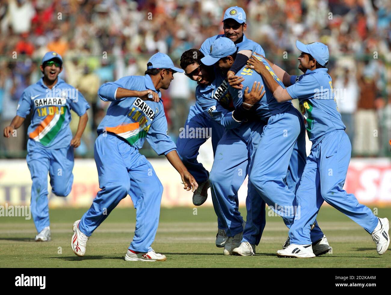 India's cricket team players celebrate the dismissal of England's Kabir Ali  during their first one-day international cricket match in New Delhi March  28, 2006. Off-spinner Harbhajan Singh captured a career-best five for