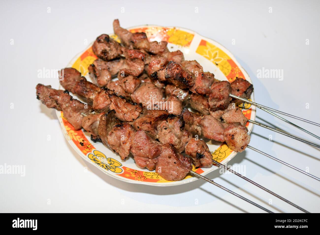 Sate Klathak or Klatak Satay is a unique goat satay or mutton satay dish with steel stick, traditional satay from Yogyakarta, Indonesia. Isolated on w Stock Photo