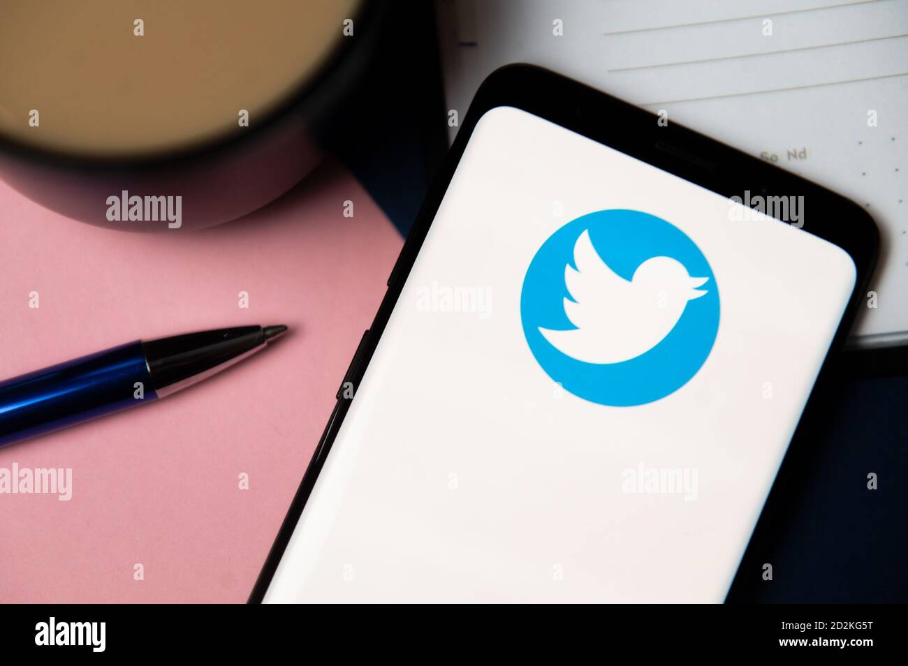 In this photo illustration a Twitter logo displayed on a smartphone