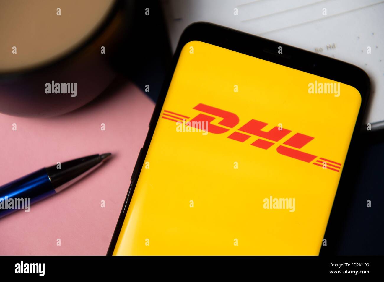 In this photo illustration a DHL logo displayed on a smartphone Stock ...