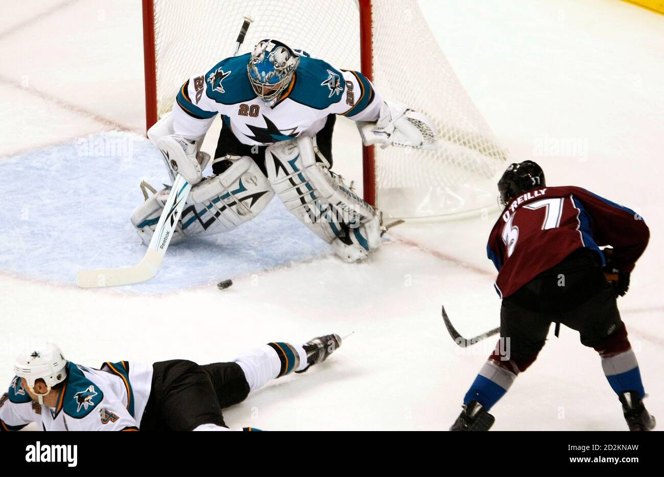 San Jose Sharks goalie Evgeni Nabokov (C) deflects a shot by  Colorado Avalanche center Ryan O'Reilly in Game 3 of their NHL Western Conference quarter-final hockey game in Denver April 18, 2010. REUTERS/Rick Wilking (UNITED STATES - Tags: SPORT ICE HOCKEY) Stock Photo